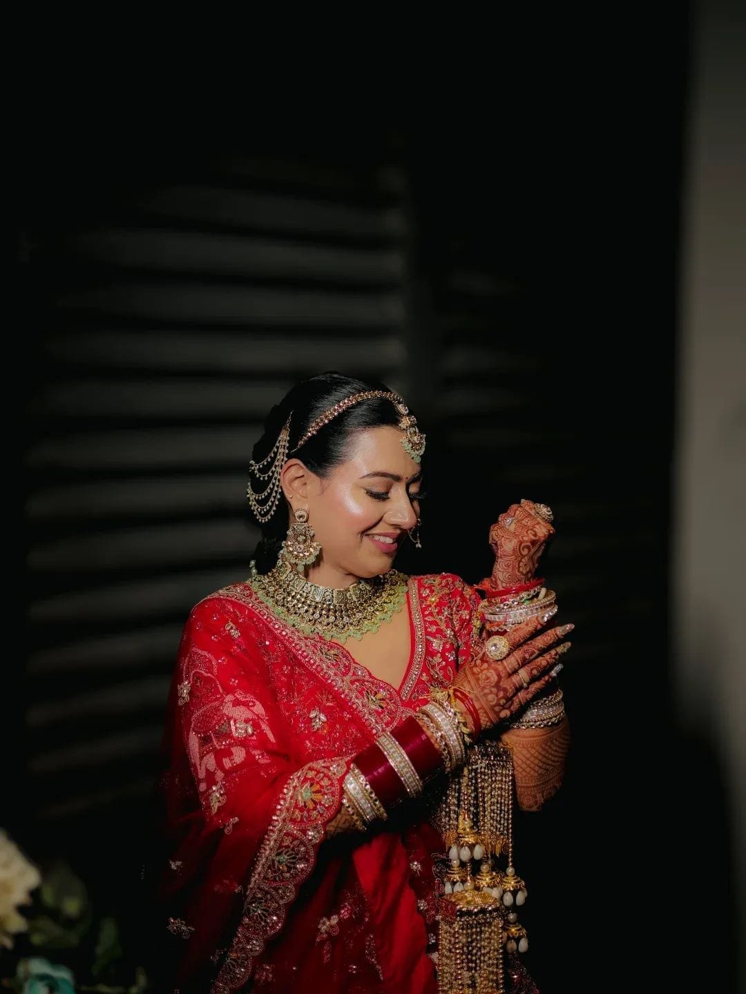 The bride's mehendi hands resting in her lap