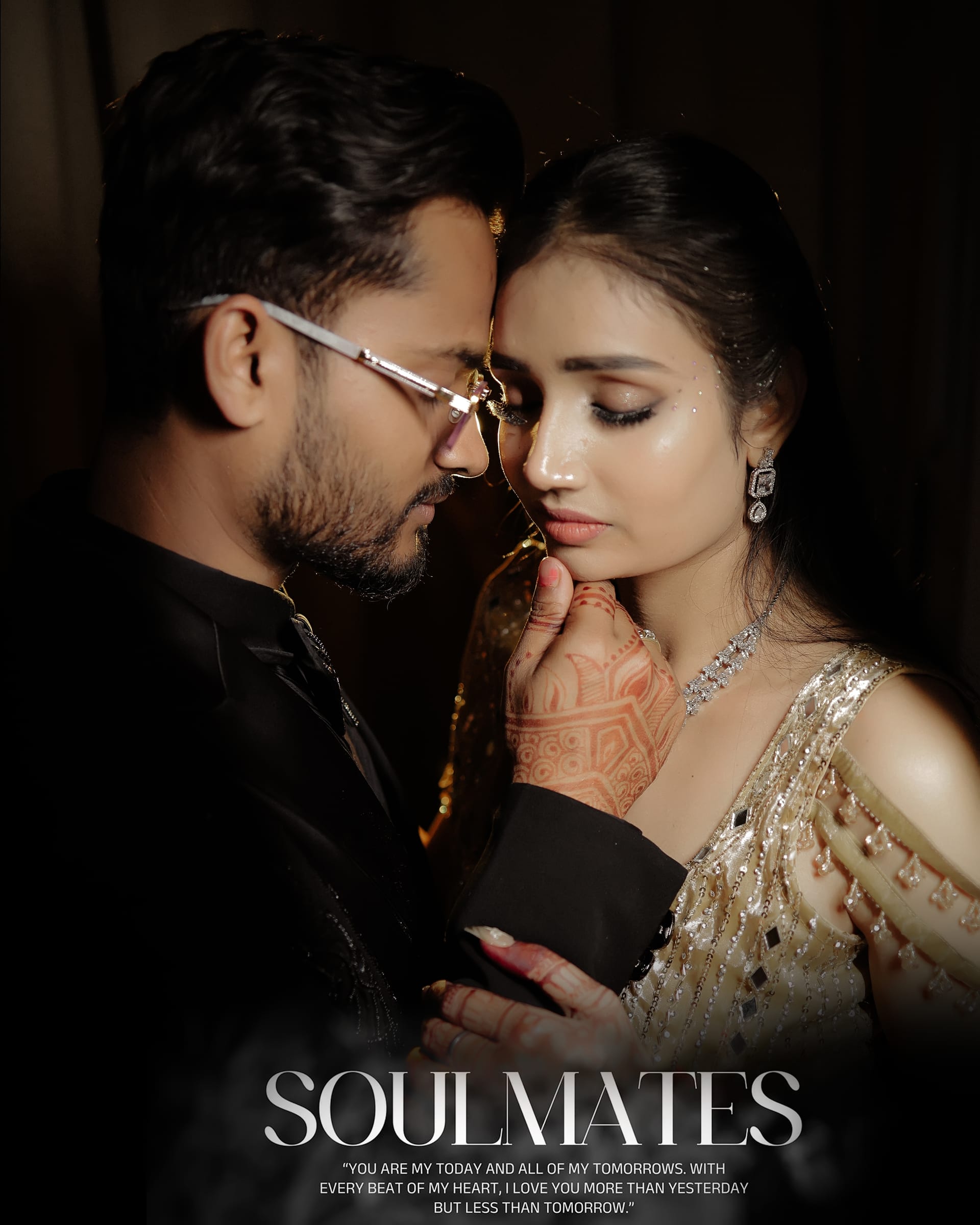 The couple close together, her gold lehenga catching the light